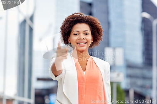 Image of happy african businesswoman pointing finger on you