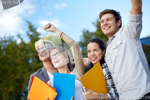 Image of group of happy students showing triumph gesture