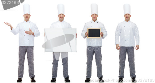 Image of happy male chef cook holding blank menu board