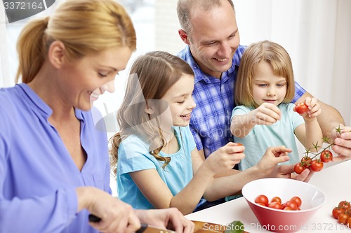 Image of happy family with two kids cooking at home