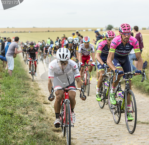 Image of The Peloton on a Cobblestoned Road - Tour de France 2015