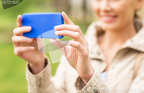 Image of close up of woman taking picture with smartphone