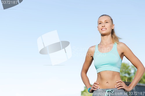 Image of happy young woman exercising outside