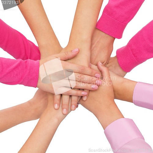 Image of close up of women with hands on top