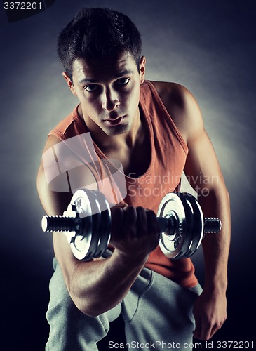 Image of young man with dumbbell