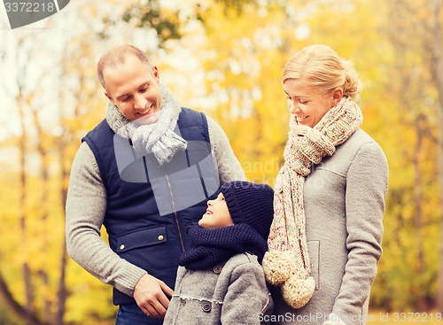 Image of happy family in autumn park