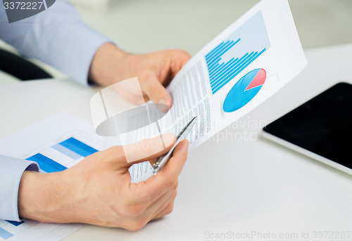 Image of close up of businessman hands with charts