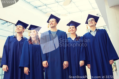 Image of group of smiling students in mortarboards