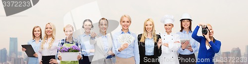 Image of woman holding money over professional workers