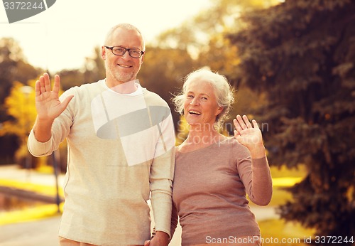 Image of senior couple hugging in city park