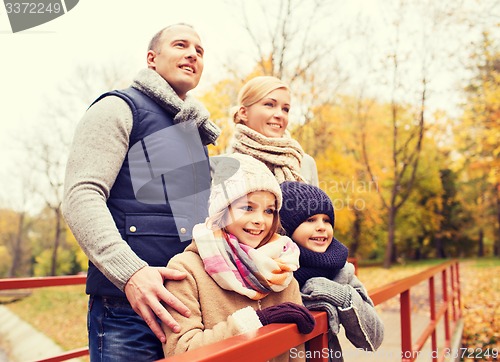 Image of happy family in autumn park
