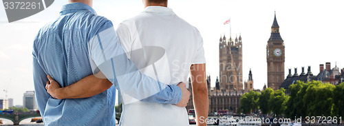 Image of close up of male gay couple hugging over big ben