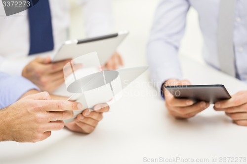 Image of close up of businessman hands with tablet pc
