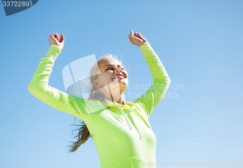 Image of woman runner celebrating victory