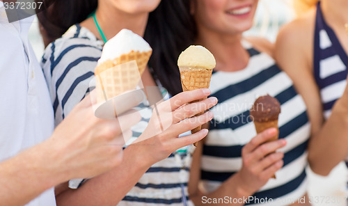 Image of close up of happy friends eating ice cream