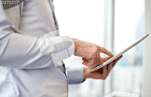 Image of businessman with tablet pc in office