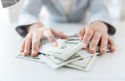 Image of close up of woman hands counting us dollar money