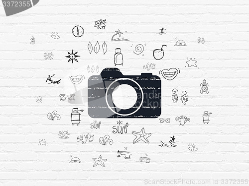 Image of Vacation concept: Photo Camera on wall background