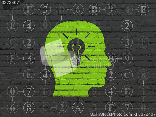 Image of Information concept: Head With Light Bulb on wall background