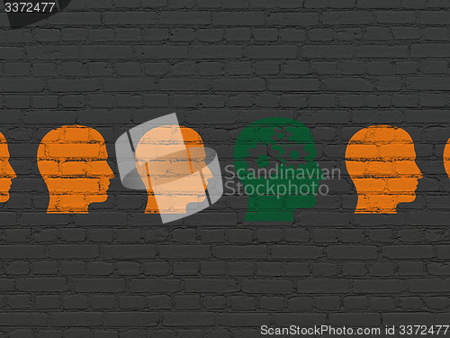 Image of Education concept: head with gears icon on wall background