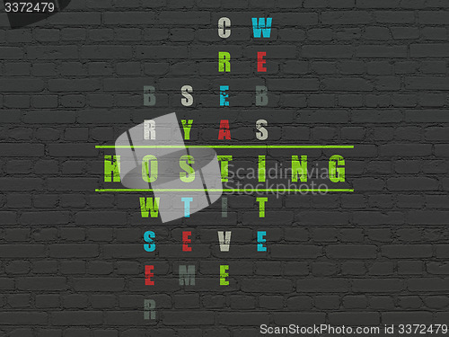 Image of Web development concept: word Hosting in solving Crossword Puzzle