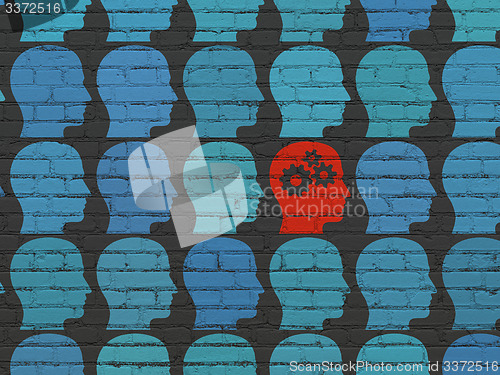 Image of Learning concept: head with gears icon on wall background