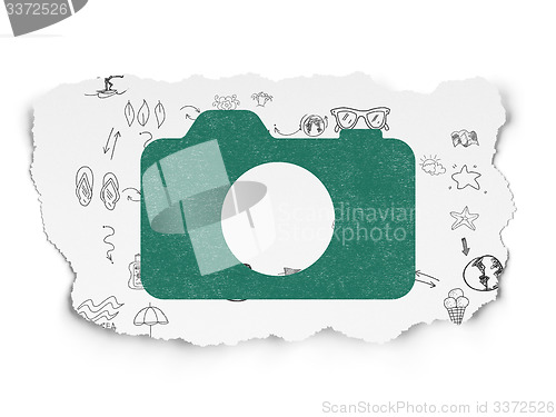 Image of Travel concept: Photo Camera on Torn Paper background