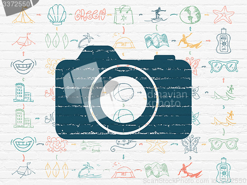 Image of Travel concept: Photo Camera on wall background