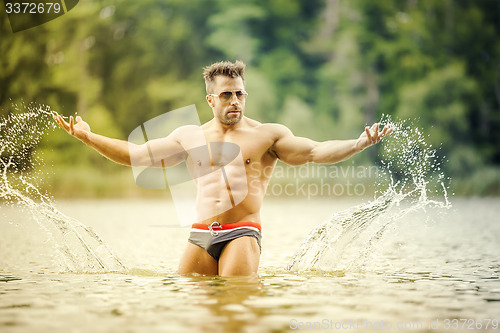 Image of muscular man lake