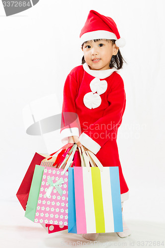 Image of Asian Little Santa Claus with shopping bag