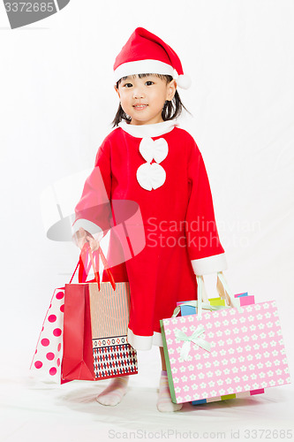 Image of Asian Little Santa Claus with shopping bag