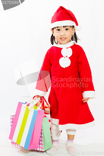 Image of Asian Little Santa Claus with shopping bag