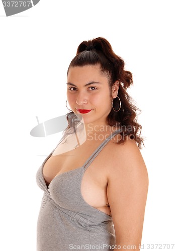 Image of Smiling woman in gray dress in profile.