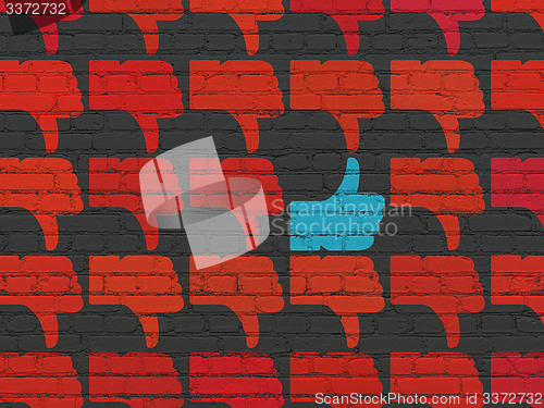 Image of Social network concept: thumb up icon on wall background