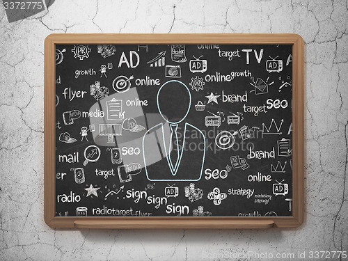 Image of Marketing concept: Business Man on School Board background