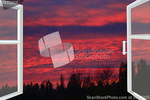 Image of window opened to the dark scarlet sunset