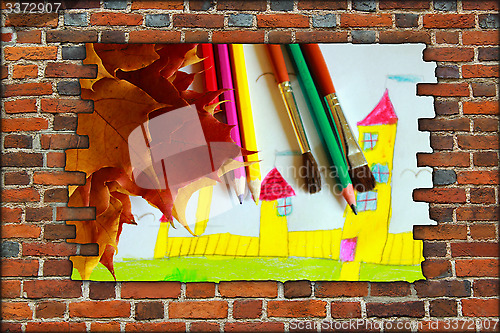 Image of wall and children's drawing of house and leaves