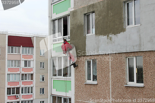 Image of specialist carring out warming of building