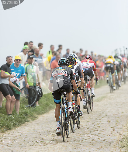 Image of The Peloton on a Cobblestoned Road - Tour de France 2015