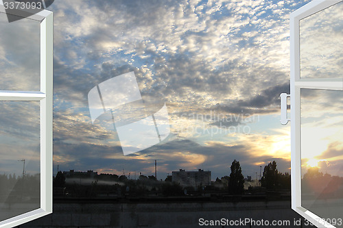 Image of window opened to the sunset