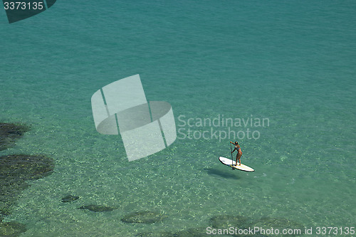 Image of Stand-up paddle in a crystalline sea beach in Fernando de Noronha,Brazil