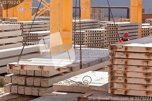 Image of Worker builder manages construction process