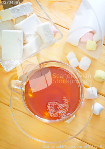 Image of Fresh tea with candy