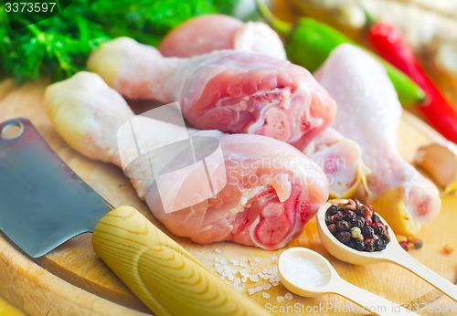 Image of Raw chicken on wooden board, Chicken with spice