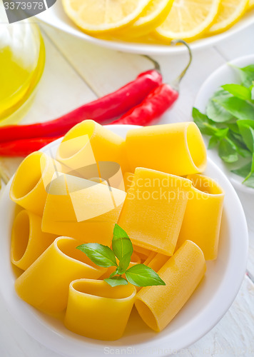 Image of raw pasta with aroma spice and oil in the bottle