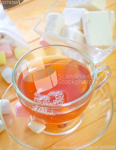 Image of Fresh tea with candy