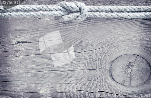 Image of rope on wooden background