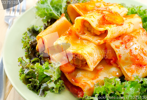 Image of pasta with sauce and salad