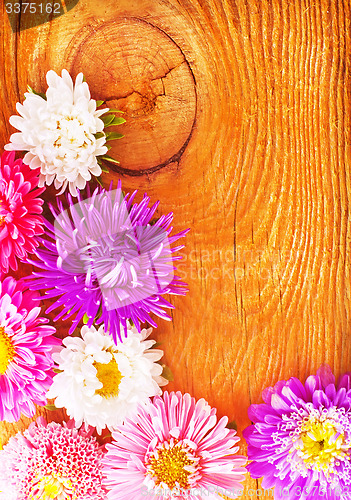 Image of flowers on wooden background