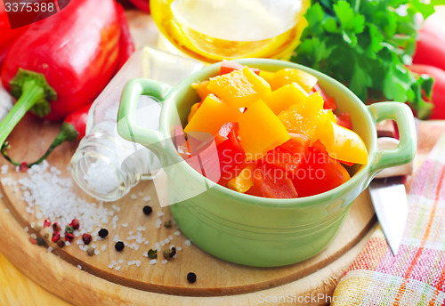 Image of Color peppers on the wooden board, pepper and knife